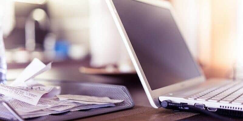 invoices-next-to-laptop Bells Accountants